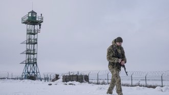 A Ukrainian border guard patrols the border with Russia