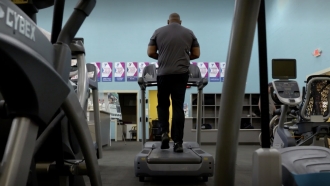 Gary Brown stands on an exercise machine.