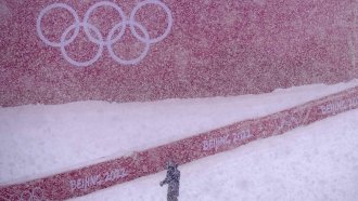 Heavy snow falls at the alpine ski venue at the 2022 Winter Olympics