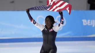 Erin Jackson of the United States hoists an American flag