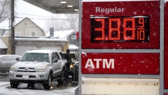 Motorists fill up vehicles at a gas station