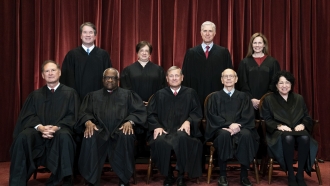 Members of the Supreme Court pose for a group photo.