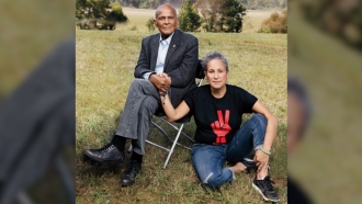 Harry Belafonte holds hands with his daughter, Gina Belafonte