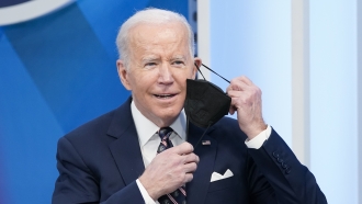 President Joe Biden removes face mask
