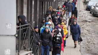 People stand in line to withdraw U.S. dollars and Euros from an ATM in St. Petersburg, Russia