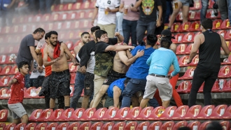 Fans clash during a Mexican soccer league match between the host Queretaro and Atlas
