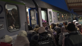 Ukrainian refugees embark a train to Poland.