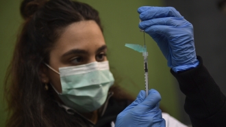 Medical staff member prepares COVID-19 vaccine