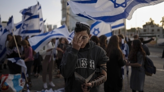 An Israeli youth prays after a wave of violence in Israel.