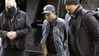 Chris Rock, center, arrives at the Wilbur Theater before a performance