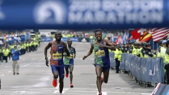 Runners sprint to the finish line to win the 123rd Boston Marathon