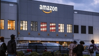 People arrive for work at the Amazon distribution center in the Staten Island borough of New York