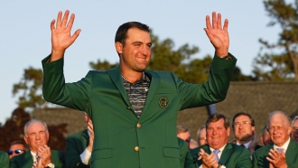 Scottie Scheffler celebrates after putting on the green jacket after winning the 86th Masters golf tournament.