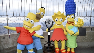 The Simpsons characters pose together on the 86th floor observation deck of The Empire State Building