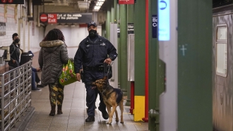 Police officers patrol a subway station in New York