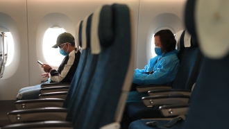 Plane passengers wear face masks