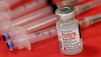 Syringes and a vial of the Moderna COVID-19 vaccine