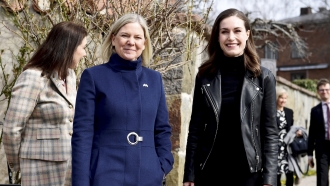 Swedish Prime Minister Magdalena Andersson and Finnish Prime Minister Sanna Marin stand together.