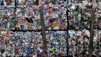 A stack of recycled aluminum cans are transported on a truck.