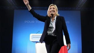 French far-right presidential candidate Marine Le Pen waves to supporters during a campaign rally.