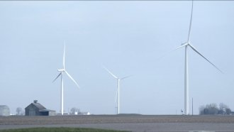 Windmills are shown on a farm.