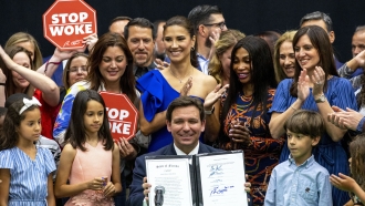 Florida Gov. Ron DeSantis smiles after publicly signing HB7, "individual freedom," also dubbed the "stop woke" bill.