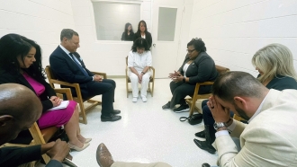 Texas death row inmate Melissa Lucio, dressed in white, leads a group of seven Texas lawmakers in prayer