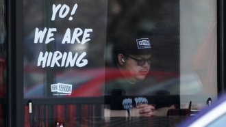 A hiring sign displayed at a restaurant