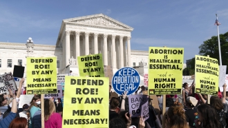Demonstrators protest outside of the U.S. Supreme Court