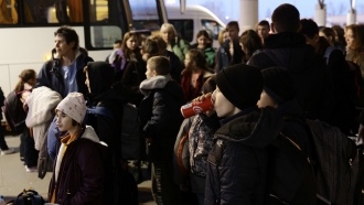 Ukrainian refugees fleeing to U.K. wait for transportation.