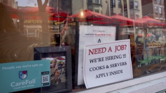Sign advertising the need for workers at a restaurant