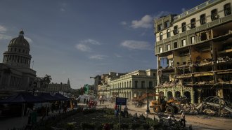 Rescue teams remove debris from the site of a deadly explosion that destroyed the five-star Hotel Saratoga, in Havana, Cuba