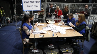 Election staff begin vote counting in Belfast in the Northern Ireland Assembly election.