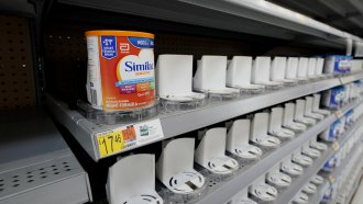 Shelves typically stocked with baby formula sit mostly empty at a store