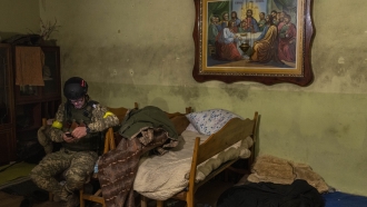 A Ukrainian National Guard soldier takes a break in a house used as a temporary base