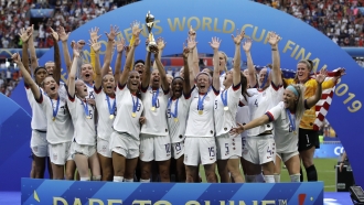 The United States' team celebrates with the trophy after winning the Women's World Cup final soccer match.