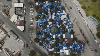Aerial shot of tents housing people seeking asylum at the U.S.-Mexico border
