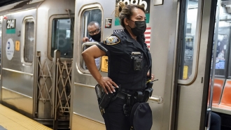 A New York City Police Department officer on a subway train platform