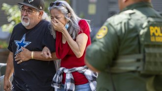 A woman cries as she leaves the Uvalde Civic Center after a school shooting