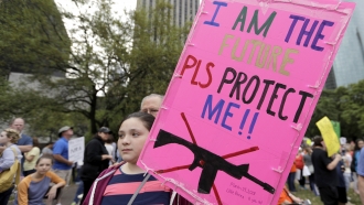 Young girl holds a sign during a "March for Our Lives" protest for gun legislation