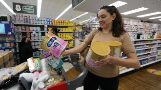 Michelle Saenz of Santee, Calif. buys baby formula at a grocery story across the border