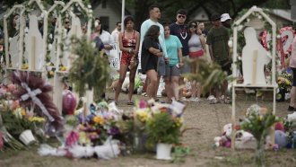 People visit a memorial outside Robb Elementary School in Uvalde, Texas.
