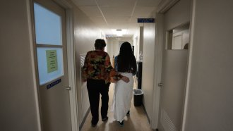 A woman walks through a clinic.