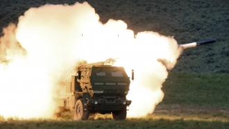 A launch truck fires the High Mobility Artillery Rocket System