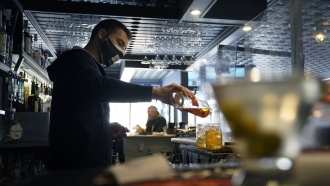 Bartender pours a drink