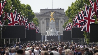 People gather on the Mall near Buckingham Palace, London ahead of the Platinum Jubilee concert