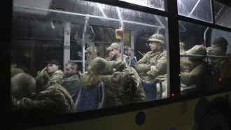 Ukrainian soldiers on a train leaving the Azovstal steel plant