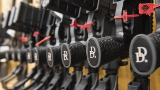 A row of AR-15 style rifles manufactured by Daniel Defense sit in a vault at the company's headquarters in Black Creek, Ga.