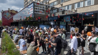 People lineup to visit a newly opened fast food restaurant in a former McDonald's outlet in Moscow