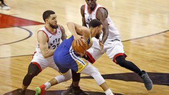Golden State Warriors' Stephen Curry is trapped by Toronto Raptors' Fred VanVleet and Pascal Siakam.